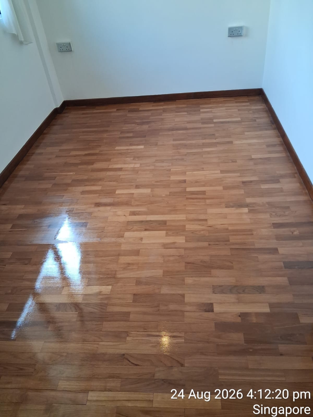 A freshly polished parquet floor with an even, glossy finish